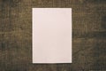 Empty white vertical rectangle poster mockup with soft shadow on darkened burlap background