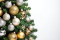 An empty white wall behind a Christmas tree. Royalty Free Stock Photo