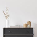 Empty white wall with black dresser, white vase and wood decor. Royalty Free Stock Photo