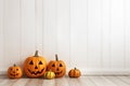 An empty white wall for Halloween mockup. Jack o lantern pumpkins decor