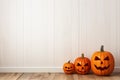 An empty white wall for Halloween mockup. Jack o lantern pumpkins decor