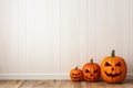 An empty white wall for Halloween mockup. Jack o lantern pumpkins decor Royalty Free Stock Photo