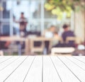 Empty white wood perspective,table top, over blur group of people team meeting at co-working space background, teamwork, business Royalty Free Stock Photo