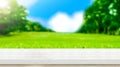 Empty white wood table top with blur green grass field natural p Royalty Free Stock Photo