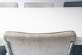 Empty white wooden dining table with modern chairs in white room, closeup Royalty Free Stock Photo