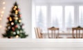 Empty white wooden table top with defocused modern dinning room and Christmas tree in the background for design