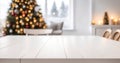 Empty white wooden table top with defocused modern dinning room and Christmas tree in the background for design. Royalty Free Stock Photo