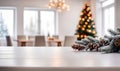 Empty white wooden table top with defocused modern dinning room and Christmas tree in the background for design