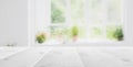 Empty white wooden table top with out of focus lights bokeh green garden background behind window Royalty Free Stock Photo