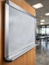 Empty whiteboard in a classroom environment, soft focus background. Royalty Free Stock Photo