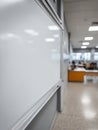 Empty whiteboard in a modern classroom setting. Royalty Free Stock Photo