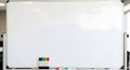 Blank whiteboard on a stand with colorful markers, ready for brainstorming and education Royalty Free Stock Photo