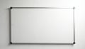 Empty whiteboard with silver frame hangs on textured wall. Blank surface awaits writing, notes, or planning. Modern office or Royalty Free Stock Photo