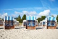 Empty wicker beach chairs on sand Royalty Free Stock Photo