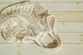 Empty wicker mesh bag on background of wooden tabletop made of sanded planks. White empty string bag
