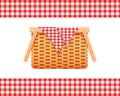 Empty wicker picnic basket with napkin and borders with checkered gingham pattern. Woven willow hamper isolated on white Royalty Free Stock Photo