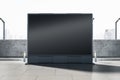 Empty wide black outdoor billboard screen on bright city background. Advertisement and commercial concept. Mock up