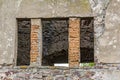Empty window hole giving view to ruins Royalty Free Stock Photo