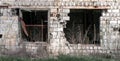 empty windows of a damaged house in Ukraine