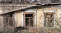 empty windows of a damaged house in Ukraine