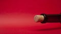 Empty wine bottle and cork on red background. alcohol  romantic drink concept Royalty Free Stock Photo