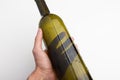 Empty wine bottle without label in hand on a white background Royalty Free Stock Photo