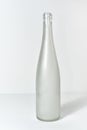 Empty wine bottle without label standing on a table Royalty Free Stock Photo