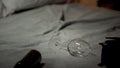 Empty wine glass and bottle lying on bed, alcohol abuse concept, alcoholism Royalty Free Stock Photo