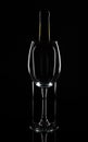 Empty wine glass in front of the wine bottle, isolated on black background Royalty Free Stock Photo