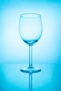 Empty wine glass with reflection in blue light