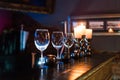 Empty wine glasses and candles with illumination lights background