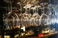 Empty wine glasses hanging on rack in bar Royalty Free Stock Photo