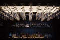 Empty wine glasses hanging upsidedown in bar interior.