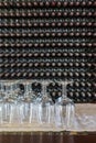 Empty wine glasses with many  stacked bottles as a background - preparation to wine tasting in winery, Lanzarote, Spain Royalty Free Stock Photo