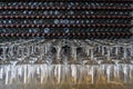 Empty wine glasses with many  stacked bottles as a background - preparation to wine tasting in winery, Lanzarote, Spain Royalty Free Stock Photo