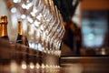 Empty wine glasses in a row on the bar, and in the background bottles of champagne Royalty Free Stock Photo