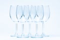 Empty wine glasses stand symmetrically on white