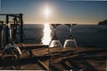 Empty wine glasses on the table against sea and sunset Royalty Free Stock Photo