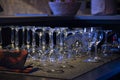 Empty wine, water, juice glasses on bar, bar interior, equipment for parties in dark light Royalty Free Stock Photo