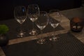 Empty wine, water, juice glasses on bar, bar interior, equipment for parties in dark light Royalty Free Stock Photo