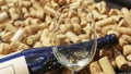 Empty wineglass on the defocused or bokhe background of wine bottle and corks. Wine concept. Space for text Royalty Free Stock Photo