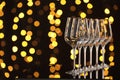 Empty wineglasses on mirror surface against dark background with blurred lights, space for text. Bokeh effect Royalty Free Stock Photo