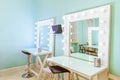 Empty woman makeup place with mirror and bulbs. Workplace makeup artist in modern makeup room. Barbershop interior