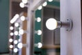 Empty woman makeup place with mirror and bulbs. Workplace makeup artist in modern makeup room. Barbershop interior