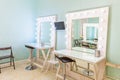 Empty woman makeup place with mirror and bulbs. Workplace makeup artist in modern makeup room. Barbershop interior