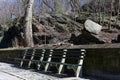 Empty Bench at a Rocky Area of Central Park near the Upper West Side of New York City Royalty Free Stock Photo