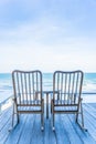 Empty wood chair and table at outdoor patio with beautiful tropical beach and sea Royalty Free Stock Photo