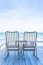 Empty wood chair and table at outdoor patio with beautiful tropical beach and sea Royalty Free Stock Photo