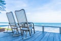 Empty wood chair and table at outdoor patio with beautiful tropical beach and sea Royalty Free Stock Photo