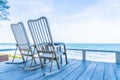 Empty wood chair and table at outdoor patio with beautiful tropical beach and sea Royalty Free Stock Photo